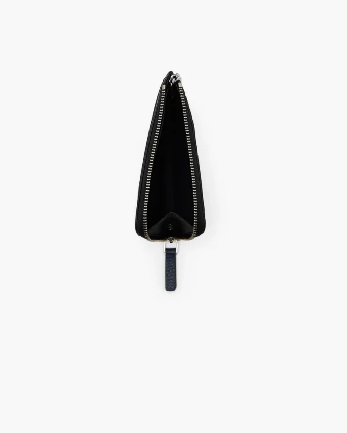 Il portafoglio multiuso in pelle con chiusura superiore a zip Il portafoglio multiuso in pelle con chiusura superiore a zip